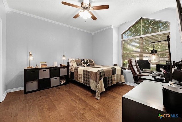 bedroom with baseboards, dark wood finished floors, a ceiling fan, and crown molding