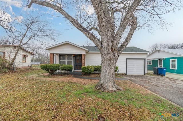 ranch-style home featuring a garage, a sunroom, and a front lawn