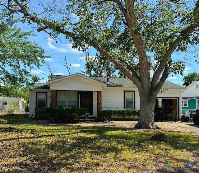 ranch-style home with a front yard and a garage