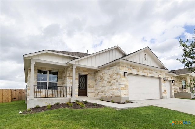 view of front facade with a garage, a front yard, and a porch