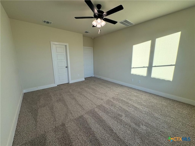 unfurnished room with carpet, baseboards, and visible vents