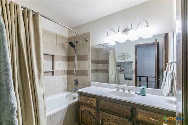 full bathroom featuring tiled shower / bath combo and vanity