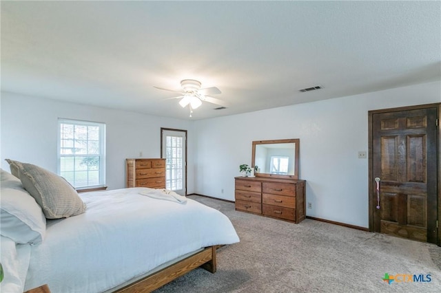 carpeted bedroom with baseboards, visible vents, and ceiling fan