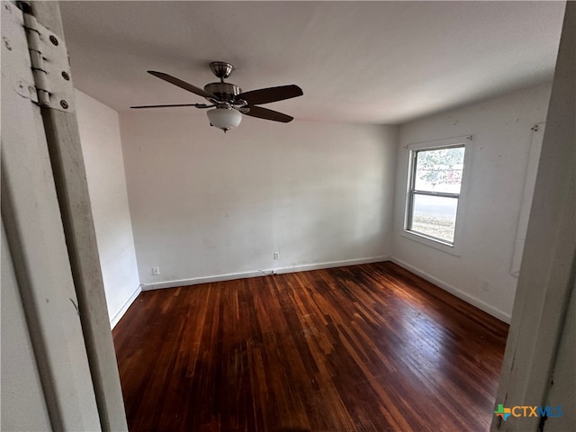 unfurnished room with ceiling fan and dark wood-type flooring