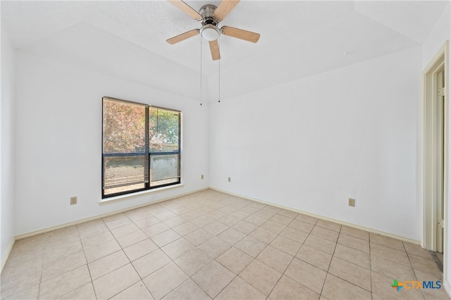 tiled spare room with ceiling fan and a textured ceiling