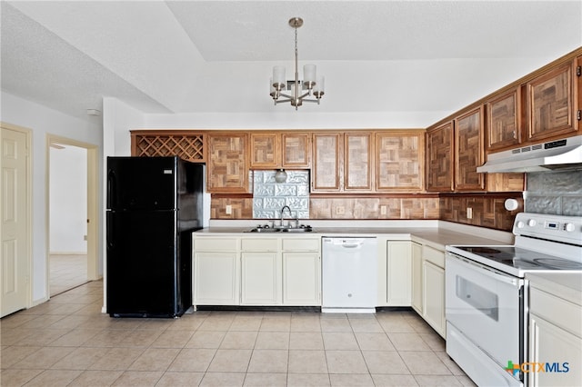 kitchen with white appliances, sink, pendant lighting, light tile patterned floors, and a chandelier