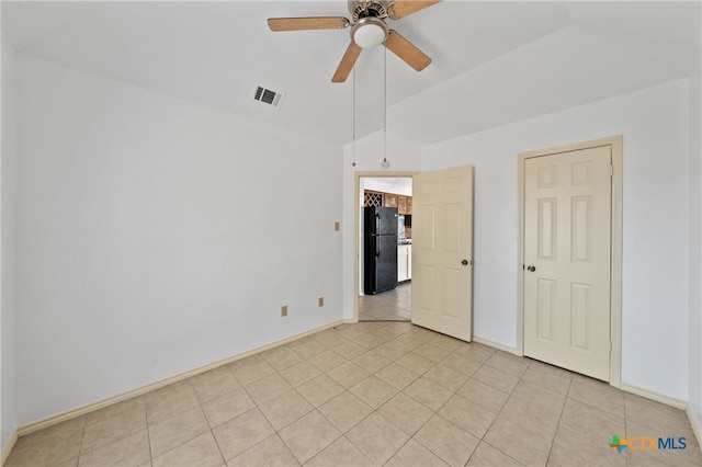 empty room with ceiling fan and light tile patterned flooring