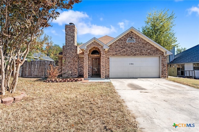 view of front of home with a front yard and a garage