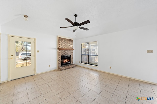 unfurnished living room with a fireplace, a healthy amount of sunlight, and light tile patterned flooring