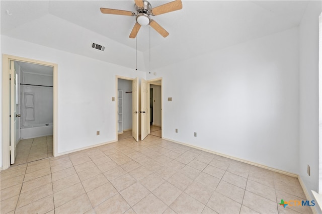 unfurnished bedroom with connected bathroom, ceiling fan, and light tile patterned flooring