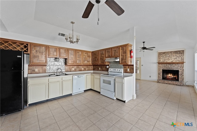 kitchen with sink, tasteful backsplash, lofted ceiling, white appliances, and light tile patterned floors