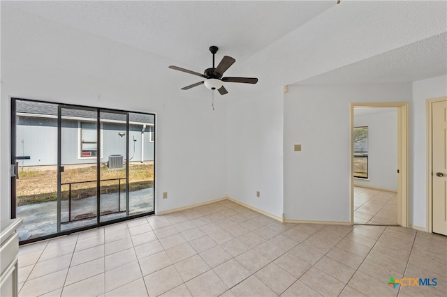 tiled empty room featuring ceiling fan and a textured ceiling