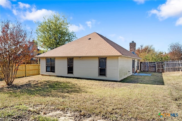 back of house with a yard