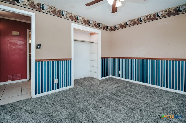 carpeted spare room with ceiling fan