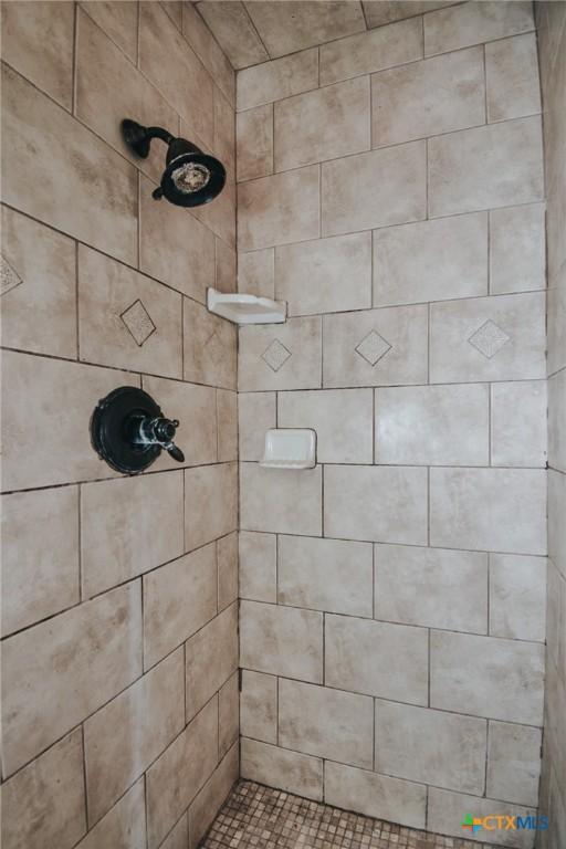 bathroom with tiled shower