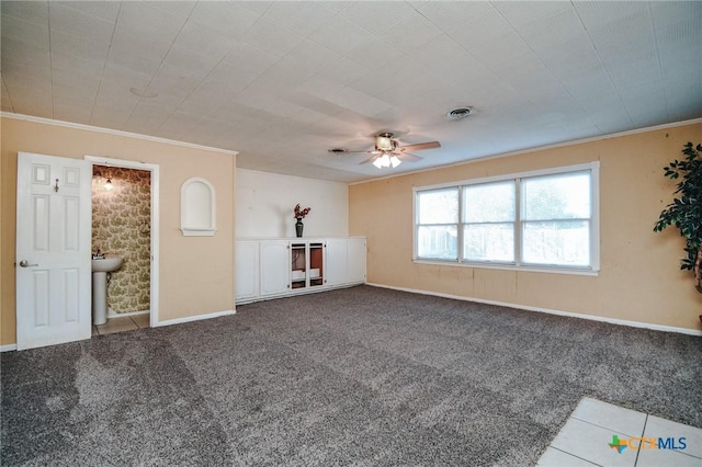 unfurnished room with ceiling fan, carpet, and crown molding