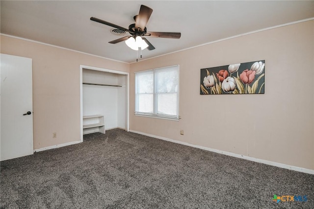 unfurnished bedroom with carpet, a closet, ceiling fan, and ornamental molding