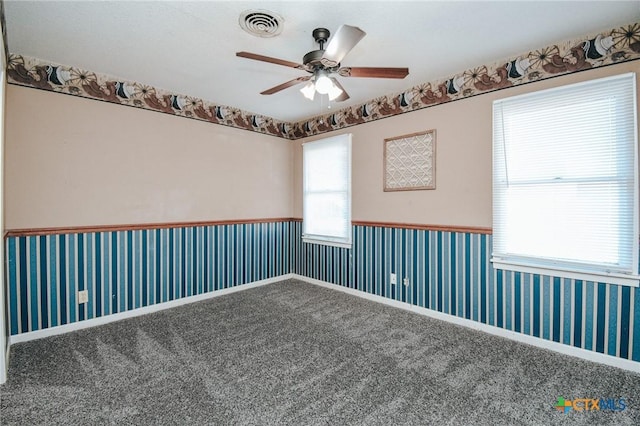 carpeted spare room with ceiling fan