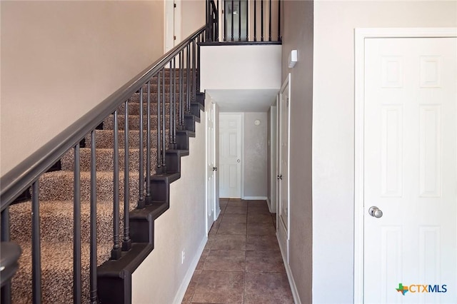 1104 Southridge, Salado, TX 76571 - staircase with baseboards, tile patterned floors, and a towering ceiling