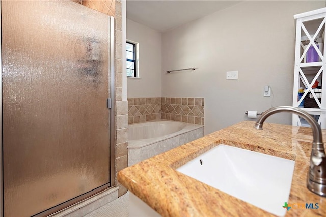 1104 Southridge, Salado, TX 76571 - full bathroom featuring a sink, a shower stall, and a garden tub