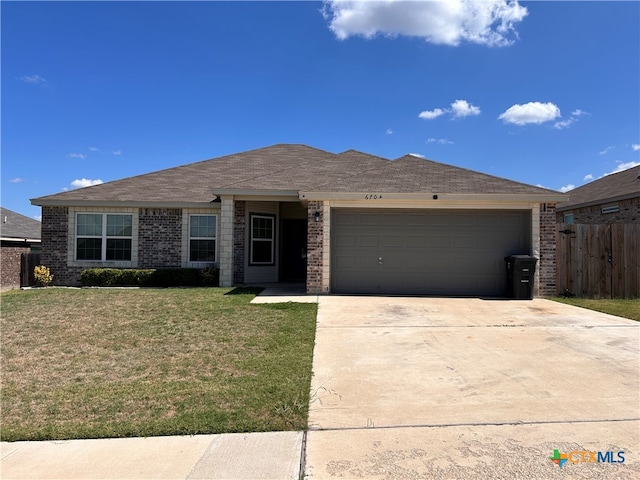 single story home featuring a front lawn and a garage