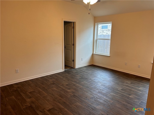 unfurnished room featuring dark hardwood / wood-style flooring, lofted ceiling, and ceiling fan