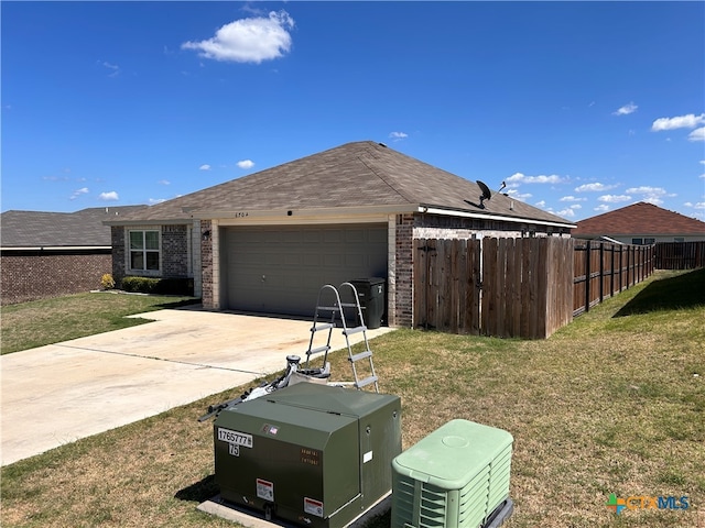 view of front of home featuring a garage and a front lawn