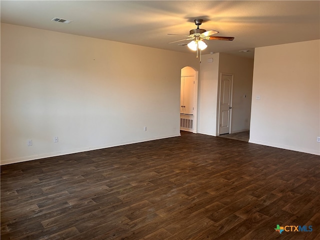 empty room with dark wood-type flooring and ceiling fan