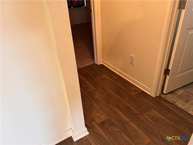 hall with dark hardwood / wood-style flooring