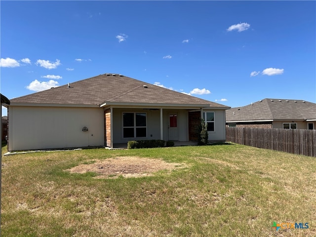 rear view of house with a lawn