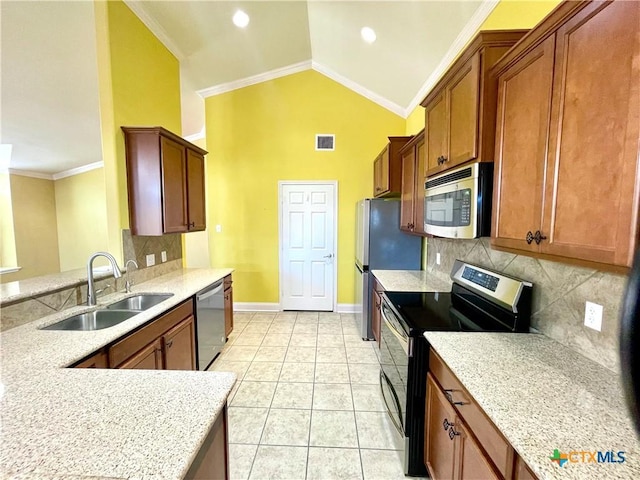 kitchen featuring lofted ceiling, a sink, visible vents, appliances with stainless steel finishes, and crown molding