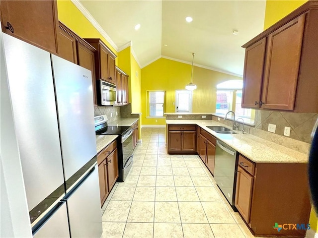 kitchen with light tile patterned floors, stainless steel appliances, a sink, vaulted ceiling, and ornamental molding