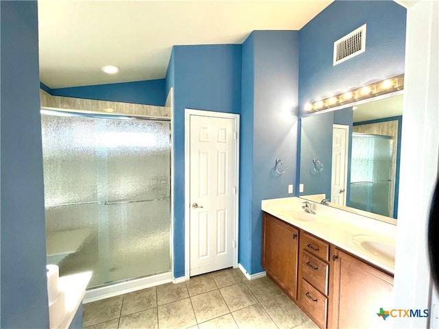 full bath featuring double vanity, visible vents, a stall shower, vaulted ceiling, and tile patterned floors