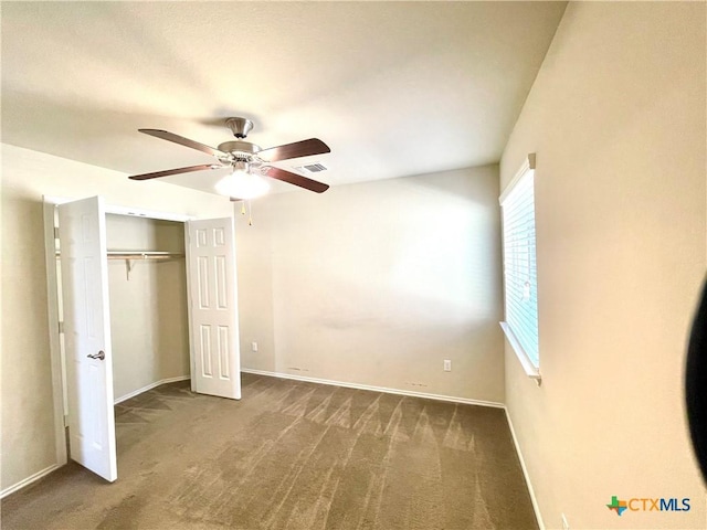 unfurnished bedroom with carpet floors, a closet, visible vents, and baseboards