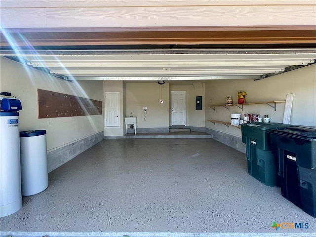 garage featuring electric panel and a sink