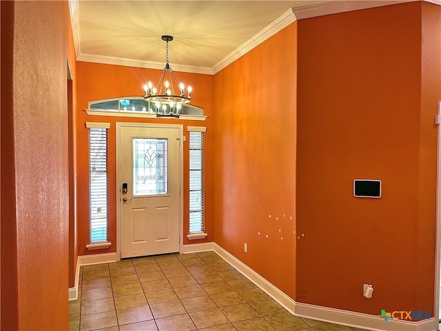 foyer featuring baseboards, ornamental molding, tile patterned floors, and an inviting chandelier