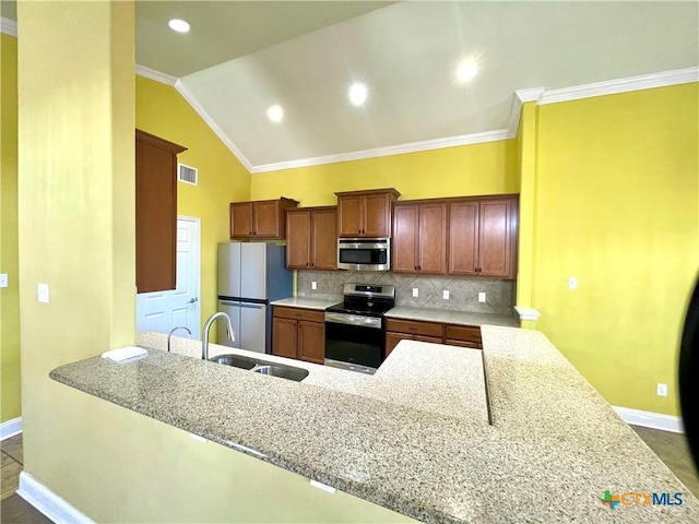 kitchen featuring appliances with stainless steel finishes, visible vents, a sink, and ornamental molding