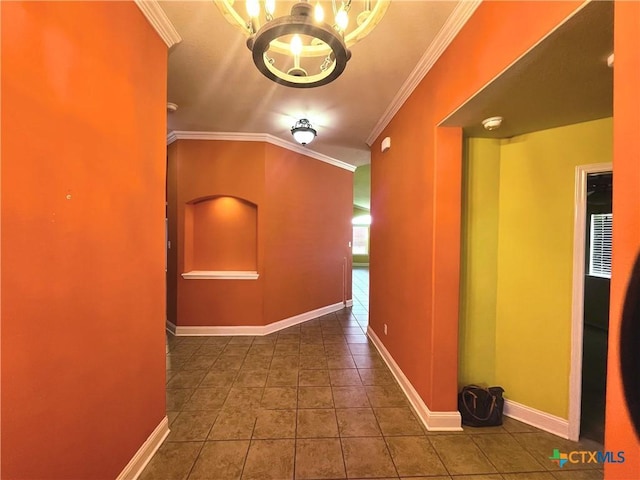 corridor featuring baseboards, an inviting chandelier, tile patterned floors, and crown molding