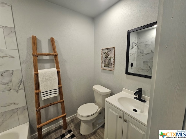 bathroom with wood-type flooring, vanity, and toilet