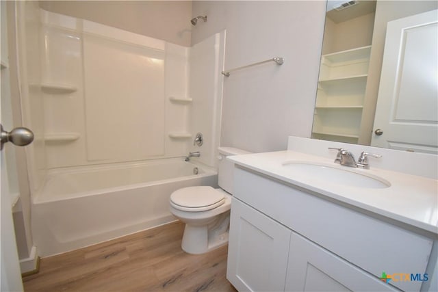 bathroom with toilet, vanity, wood finished floors, and washtub / shower combination