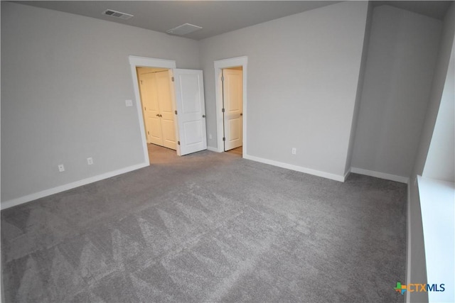 unfurnished bedroom featuring baseboards, visible vents, and carpet flooring