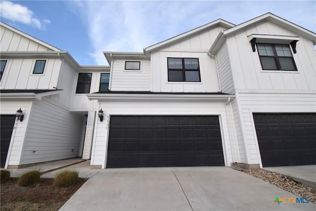 view of front of property featuring a garage, driveway, and board and batten siding