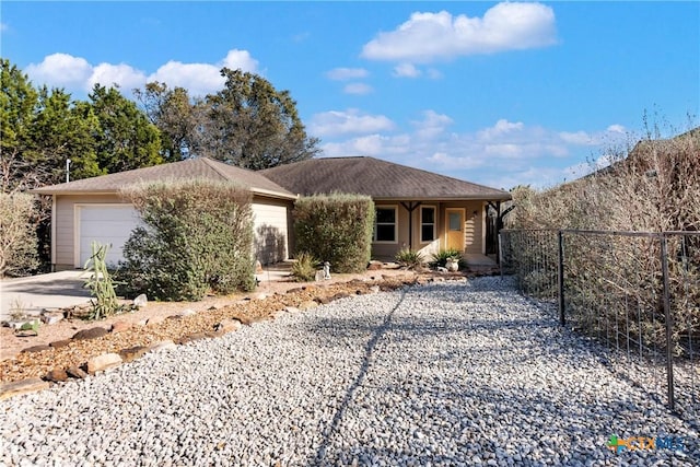 single story home with a porch, driveway, a garage, and fence