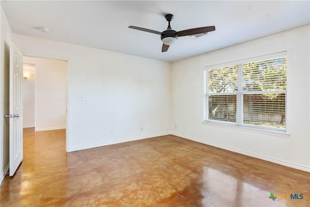 empty room with baseboards, concrete floors, and a ceiling fan