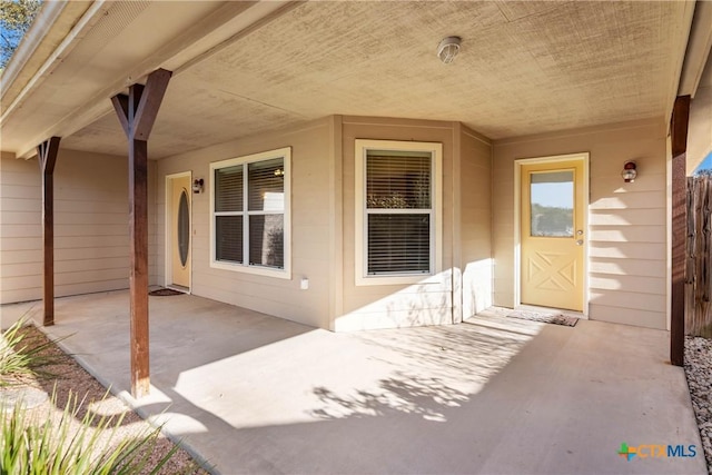 doorway to property featuring a patio