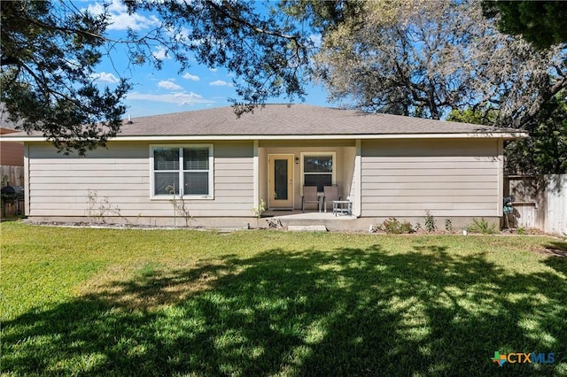 back of property featuring a yard, a patio, and fence