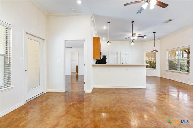 kitchen with freestanding refrigerator, visible vents, concrete floors, and ornamental molding