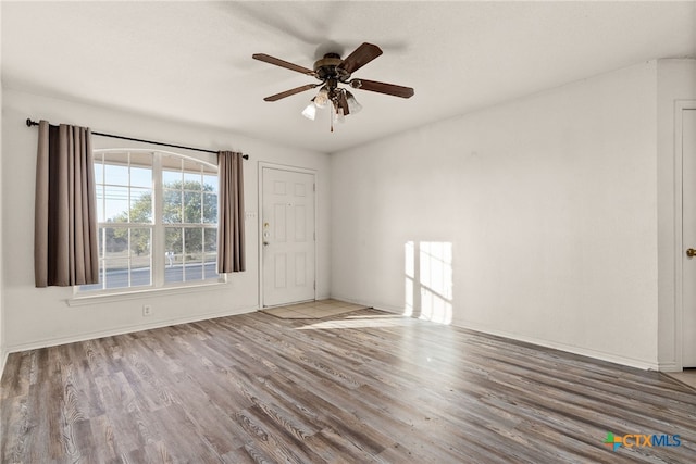 spare room with ceiling fan and hardwood / wood-style flooring