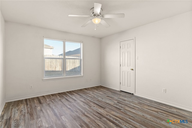 unfurnished room featuring ceiling fan and dark wood-type flooring