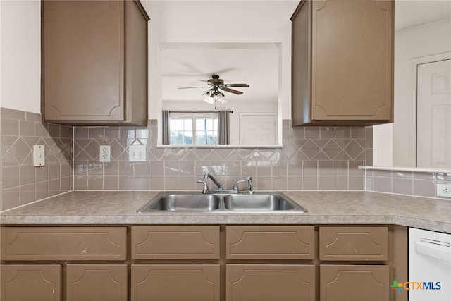 kitchen featuring decorative backsplash, ceiling fan, dishwasher, and sink